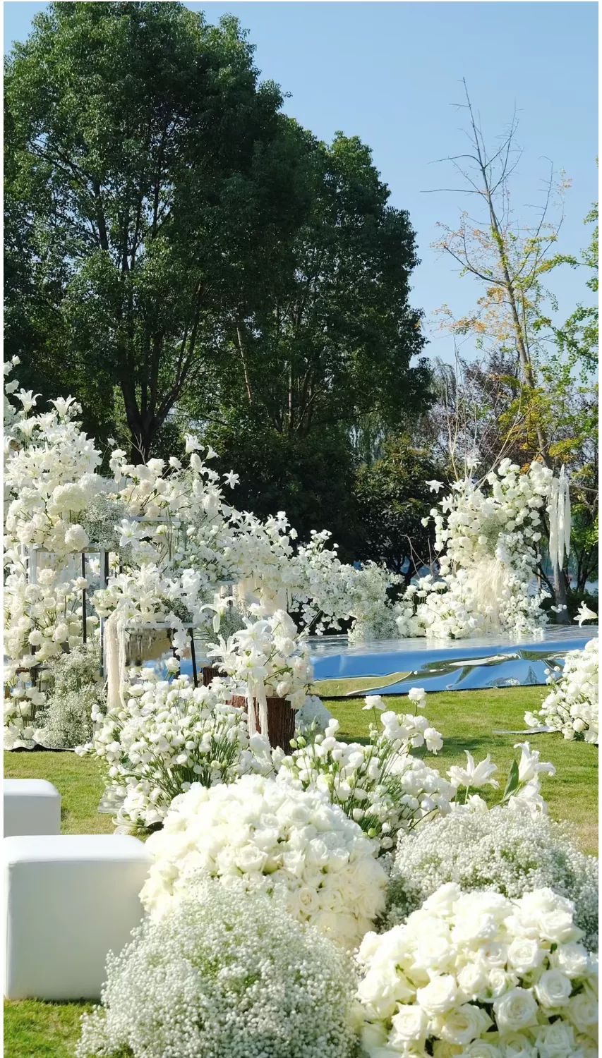 Table centerpiece with white artificial orchids for modern wedding reception