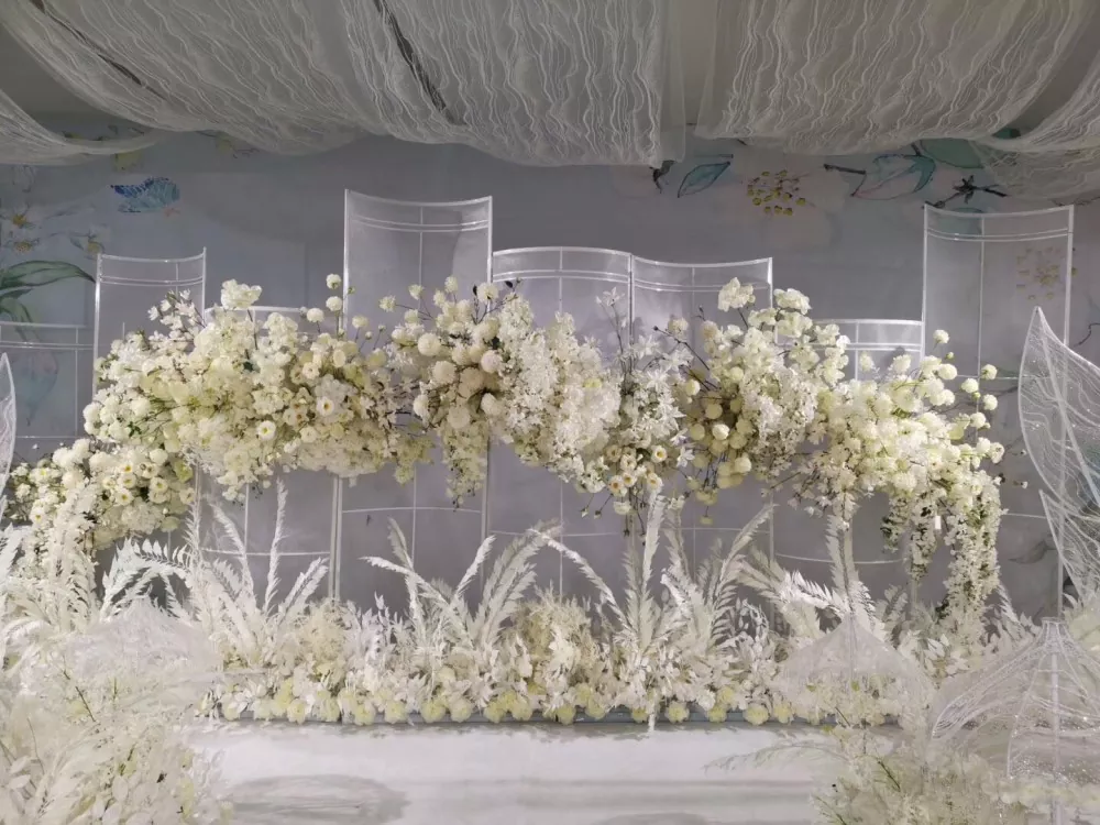 Outdoor garden wedding with white artificial roses arch and flower columns